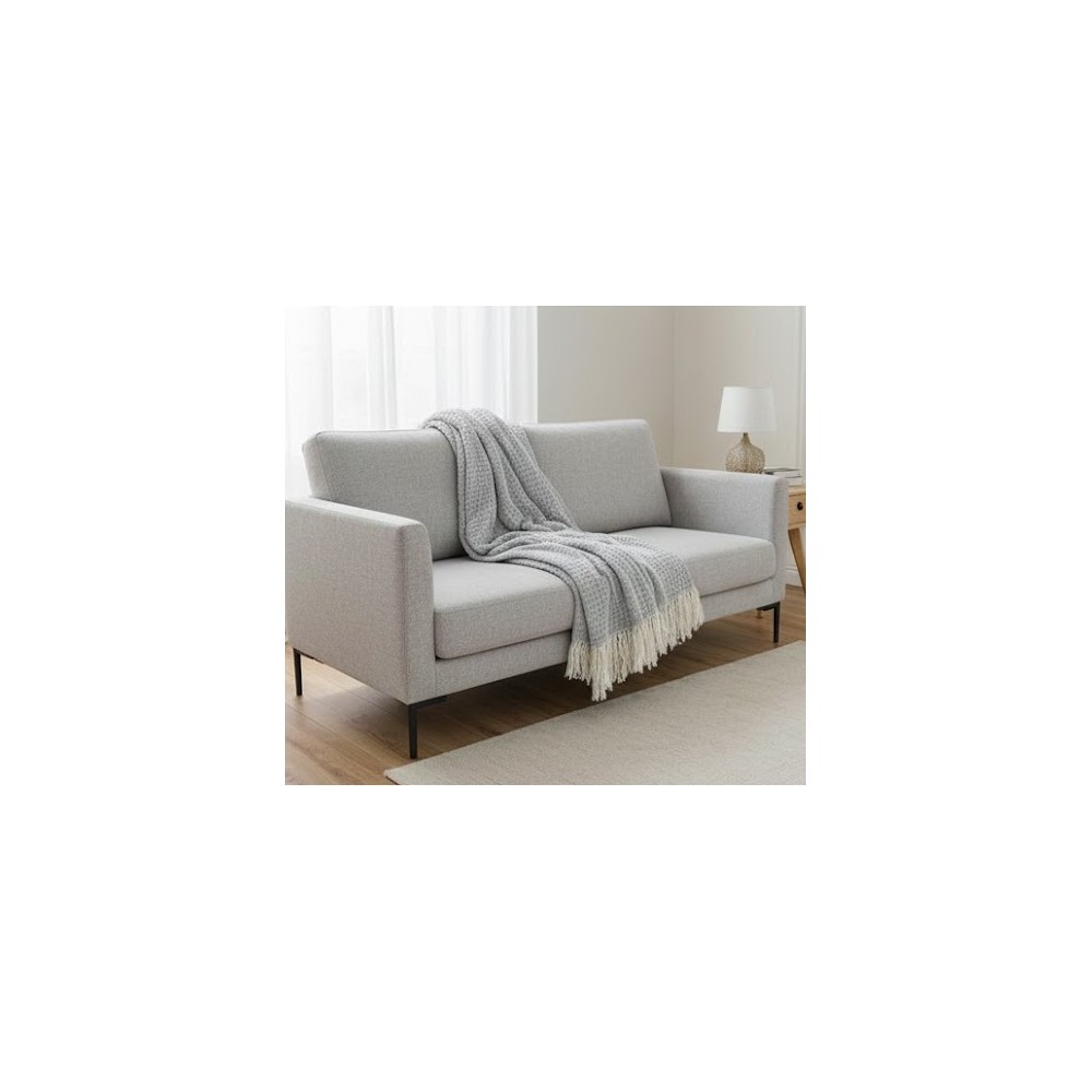 Manta multiusos de Algodón cuadros gris extendida sobre un sofa decorandolo