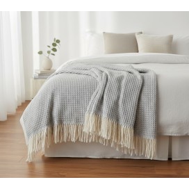 Manta multiusos de Algodón cuadros gris a los pies de una cama