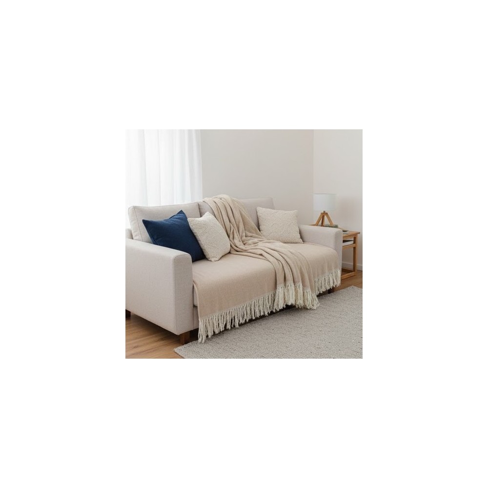 Manta multiusos algodón rayas beige 120x190 cm. extendida sobre un sofa