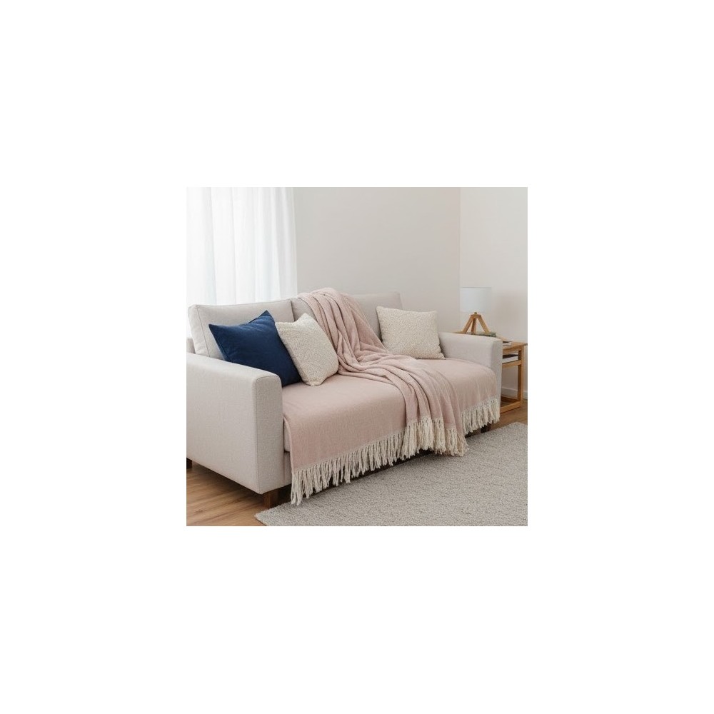 Manta multiusos algodón rayas rosa 120x190 cm. sobe un sofa en conjunto con cojines
