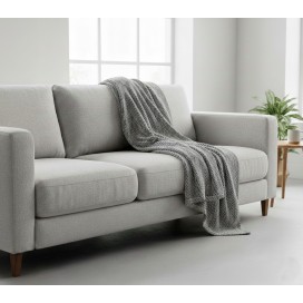 Manta multiusos algodón espiga gris marengo sobre un sofa