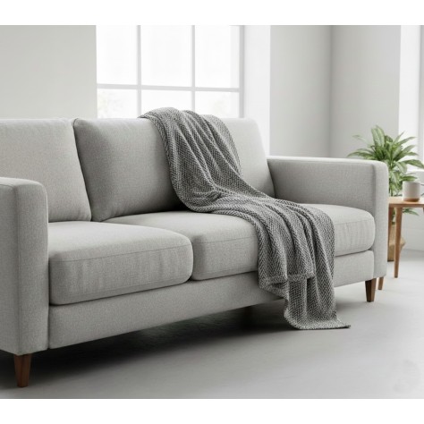 Manta multiusos algodón espiga gris marengo sobre un sofa