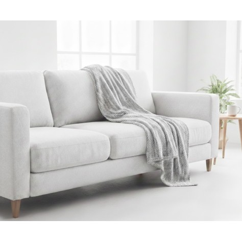 Manta multiusos algodón espiga gris perla sobre un sofa