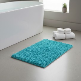 Alfombra de baño Eden Shagy de 60x40 cm en color azul turquesa con textura de microfibra de poliéster antideslizante.