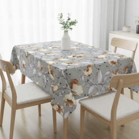 Mantel antimanchas con estampado floral botánico en tonos grises y ocres sobre mesa de comedor"