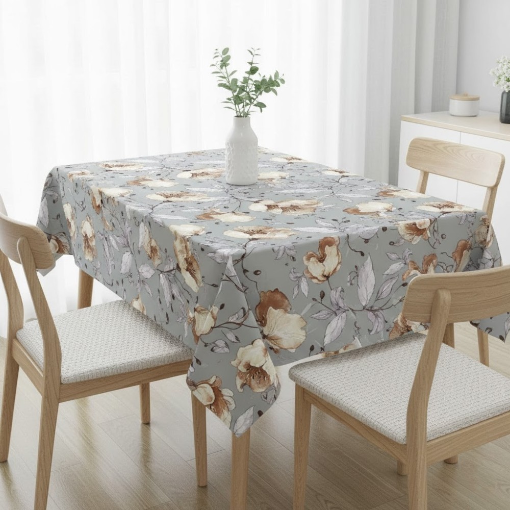 Mantel antimanchas con estampado floral botánico en tonos grises y ocres sobre mesa de comedor"