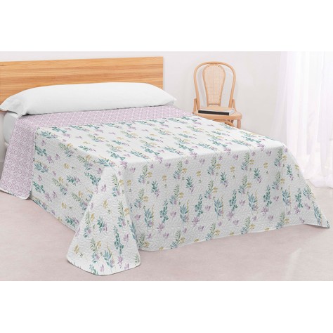 Cama vestida con colcha bouti blanca estampada con ramas botánicas y reverso geométrico color malva